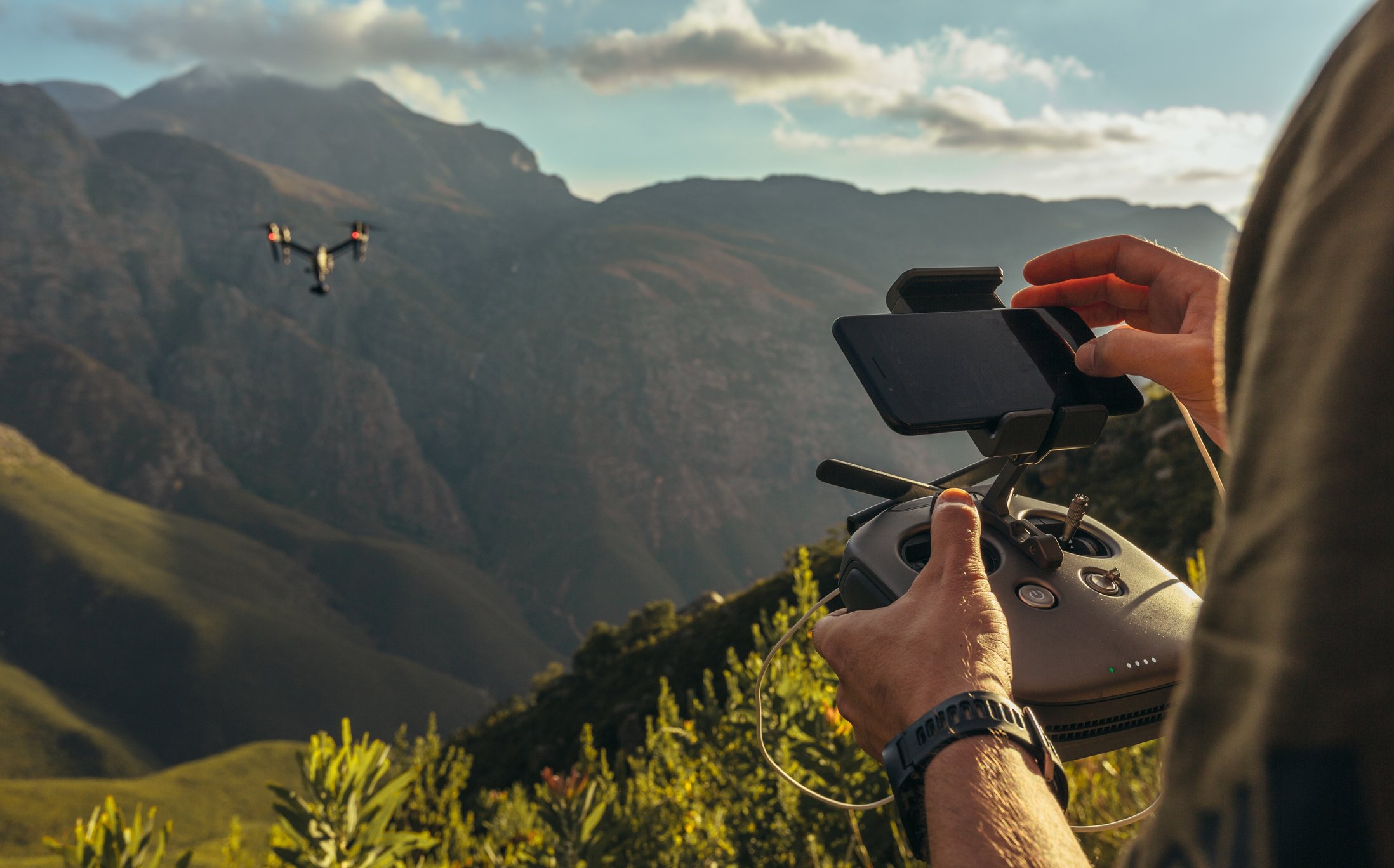 Nature Photographer Flying a Drone in Mountains